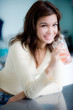 © Philip Date - A young woman having juice in the kitchen