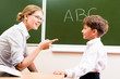 © pressmaster - Portrait of confident teacher explaining grammar