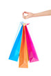 © aetherial - Female hand holding bright colored shopping bags