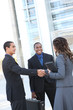 © Stephen Coburn - A diverse ethnic business team shaking hands at office