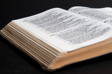 Closeup of Dutch Bible, on black background.