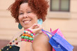 Plus size model, smiling, with shopping bags