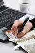 © pressmaster - Vertical image of human hand over notebook page