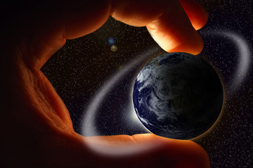 mans hand hold earth in open space