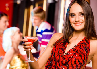 Wall Mural - Image of modern woman holding glass of martini