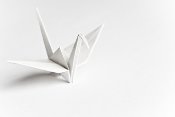 an origami bird on a white background