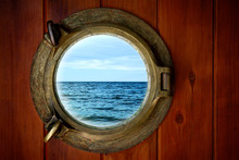 Close-up Of A Boat Closed Porthole With Ocean View