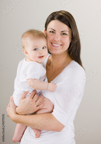 Fotografie, Obraz Studio shot of loving mother holding baby