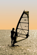 Silhouette Of A Windsurfer On Waves Of A Gulf