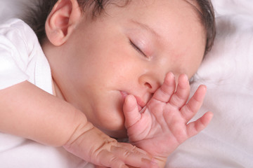 cute baby girl sleeping in her bed