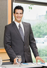 Confident businessman posing in conference room