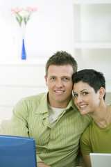 Wall Mural - Love couple working together on laptop computer at home.