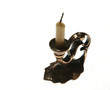 Old copper candlestick with the extinct candle