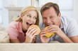 © Monkey Business - Couple Enjoying Burgers Together