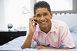 © Monkey Business - Teenage Boy Lying On Bed Using Mobile Phone
