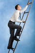 © pressmaster - Photo of young businessman climbing upwards