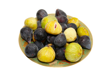 Wall Mural - Stack of black and yellow figs on the plate isolated on white.