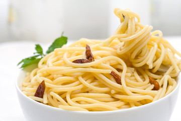 Canvas Print - spaghetti with chili pepper and olive oil on white bowl