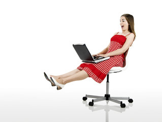 Poster - happy woman seated on a chair with a laptop