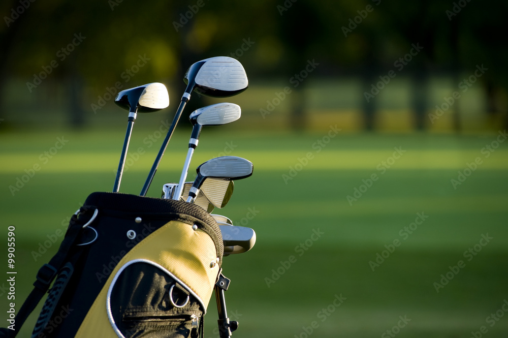 A set up new golf clubs on a beautiful golf course - obrazy, fototapety, plakaty 