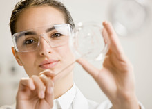 Scientist Testing Specimen In Petri Dish In Laboratory