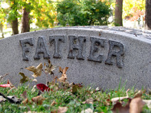 Autumn Cemetery Grave Headstone Marked With Father