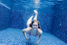 An Underwater Shot Of A Woman In A Swimming Pool