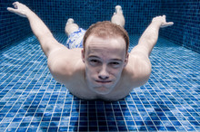 An Underwater Shot Of A Man In A Pool Holding His Breath
