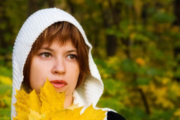 Wall Mural - young pretty woman with yellow leaves in the autumn park