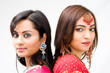 Two beautiful Bengali brides in colorful dresses, isolated