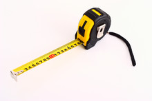 Yellow And Black Tape Measure On White Background