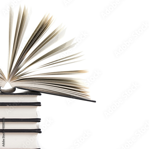 Fotografía pile of books with one book open on white background