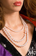 Fragment of a beautiful decollete with pearls