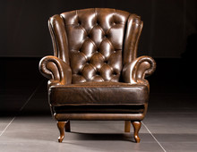 Brown Leather Armchair On A Black Background