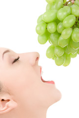 Poster - pretty woman with green grape isolated on the white background