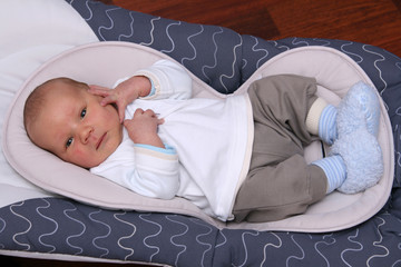 newborn baby in bouncer chair