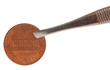 american penny being pinched with pair of tweezers