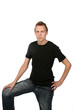 © sparkmom - handsome young man in black shirt and dark jeans