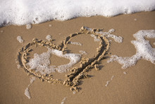 A Heart Drawn Into The Wet Sand At The Beach.