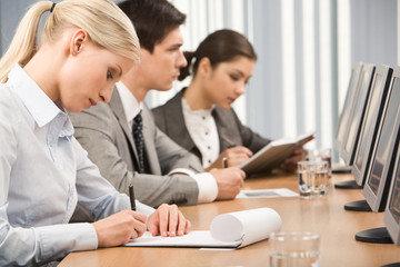 Sticker - young businesswoman making notes in her notepad