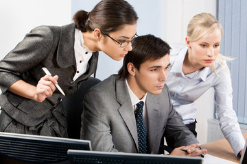 Poster - Three colleagues gazing at monitor