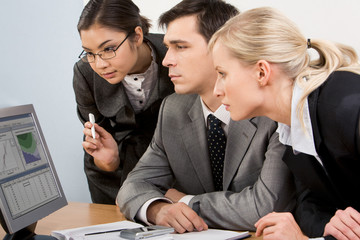 Canvas Print - Image of smart work group staring at display of computer