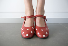 Close-up Of Feet In Red Shoes With White Dots
