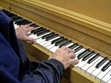Closeup On A Woman Hands Playing Piano