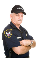 Wall Mural - Mature police officer with a suspicious expression.  Isolated