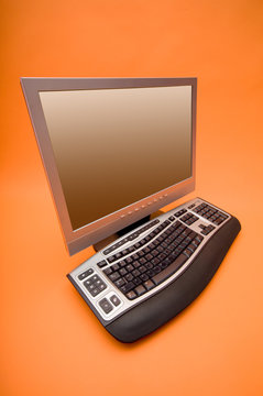 monitor and keyboard on the orange background