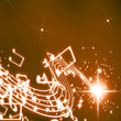 Musical notes on a glittering and brown background