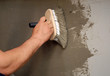 applying parget on the wall with a brush