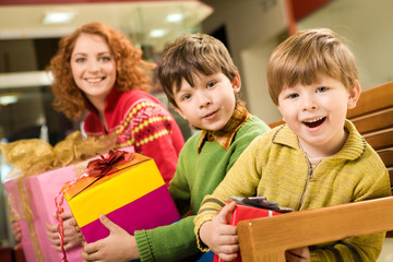 Wall Mural - Portrait of astonished brothers with nice gifts