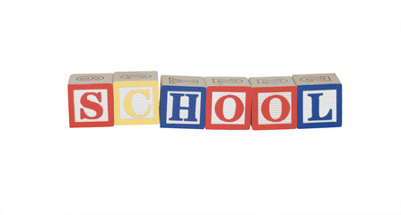 Toy block letters spelling school in primary colors